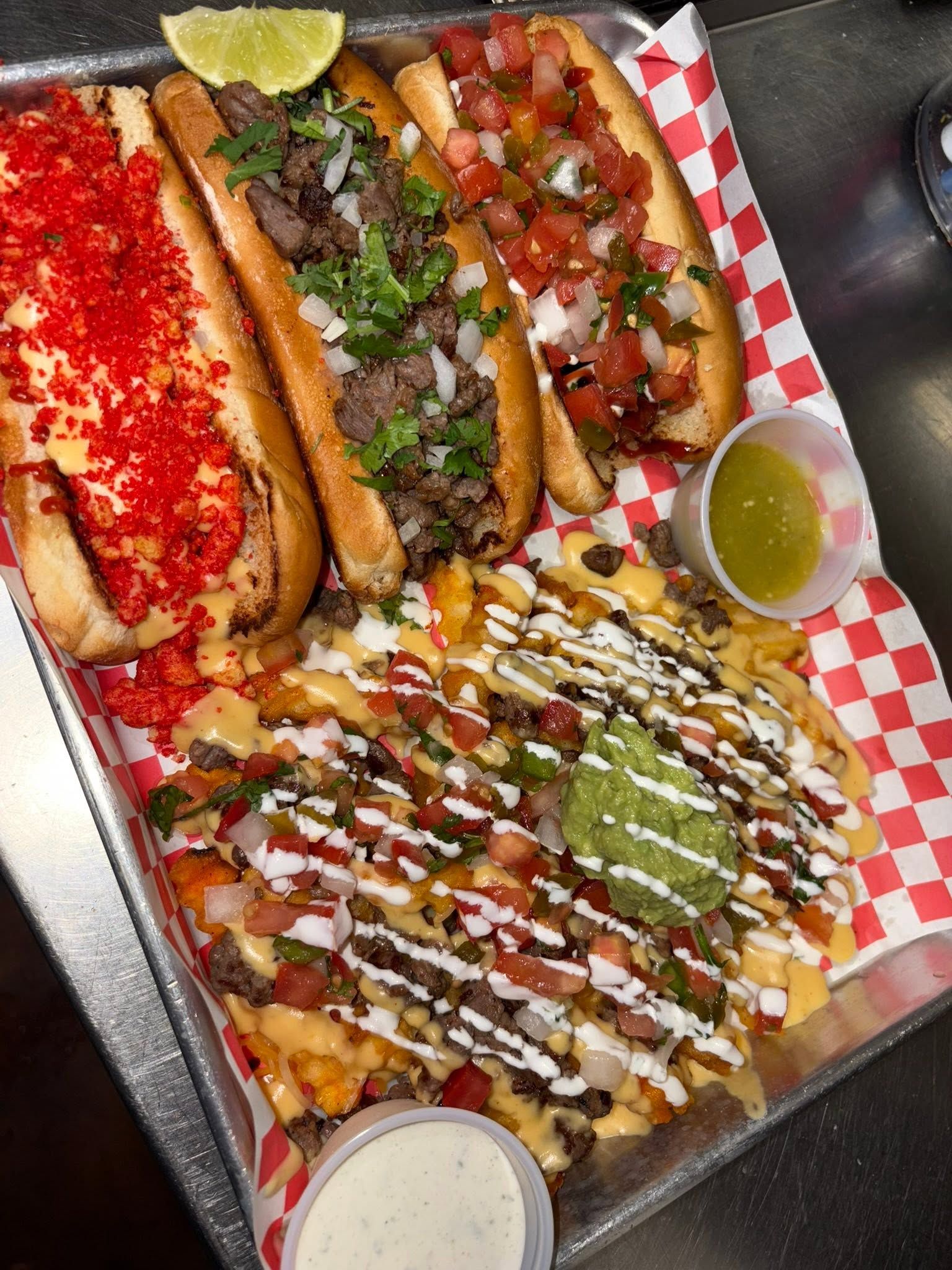 Loaded queso fries with guacamole and pico alongside hot cheeto, asada, and pico dogos