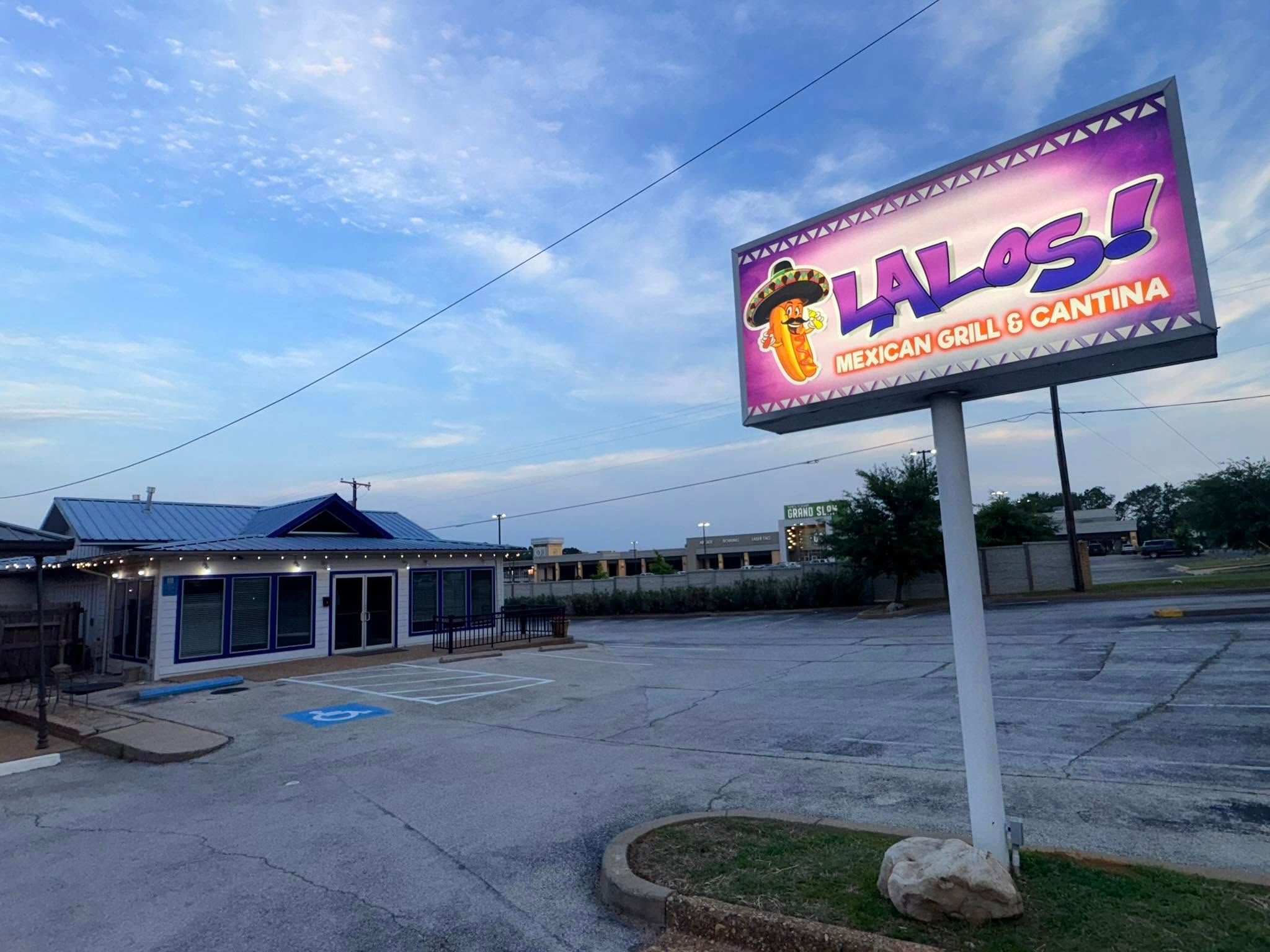 The Lalo's Mexican Grill & Cantina sign lit up at dusk on Old Bullard Rd