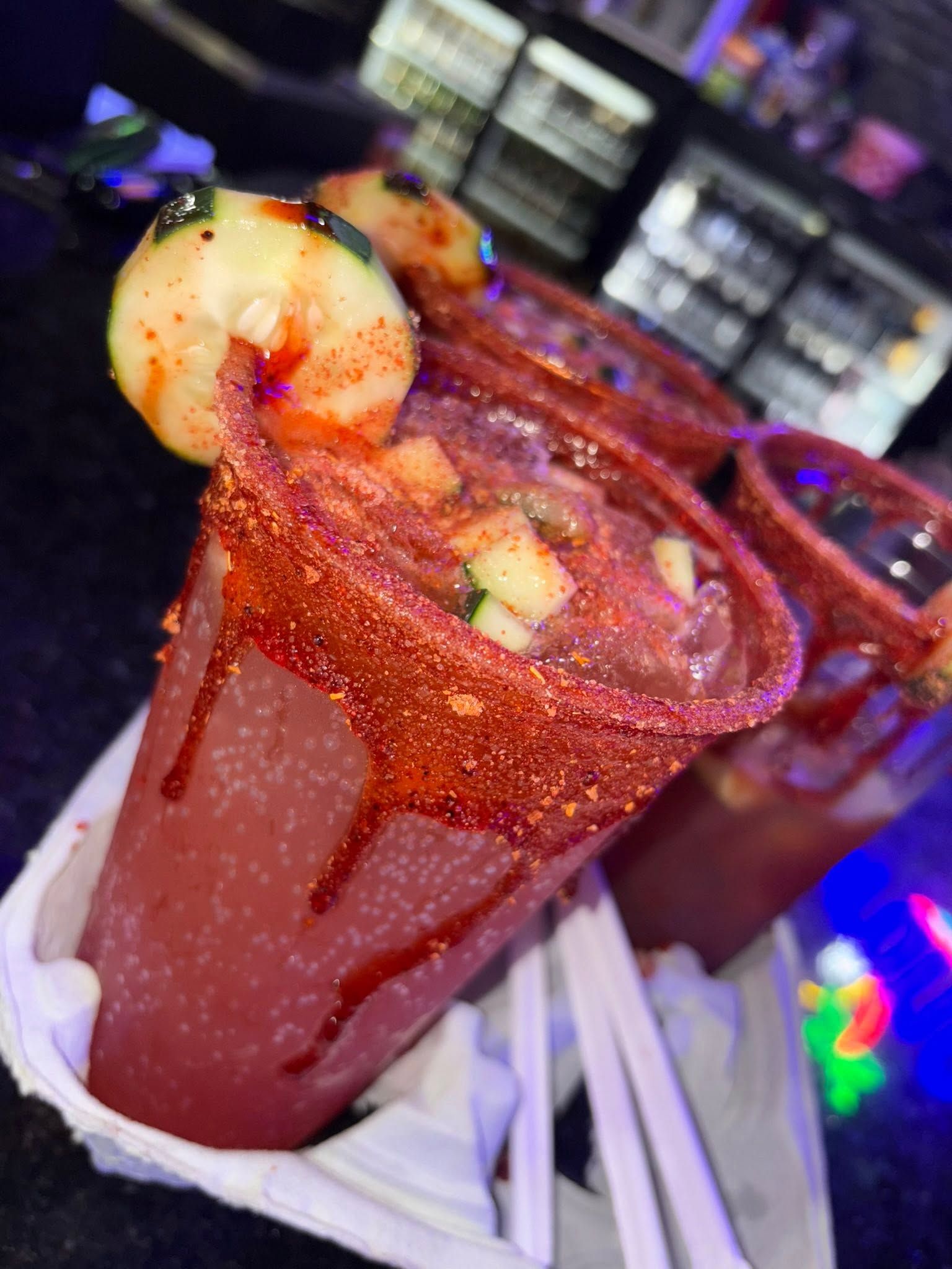 A michelada with a chile-salt rim, shrimp and cucumber