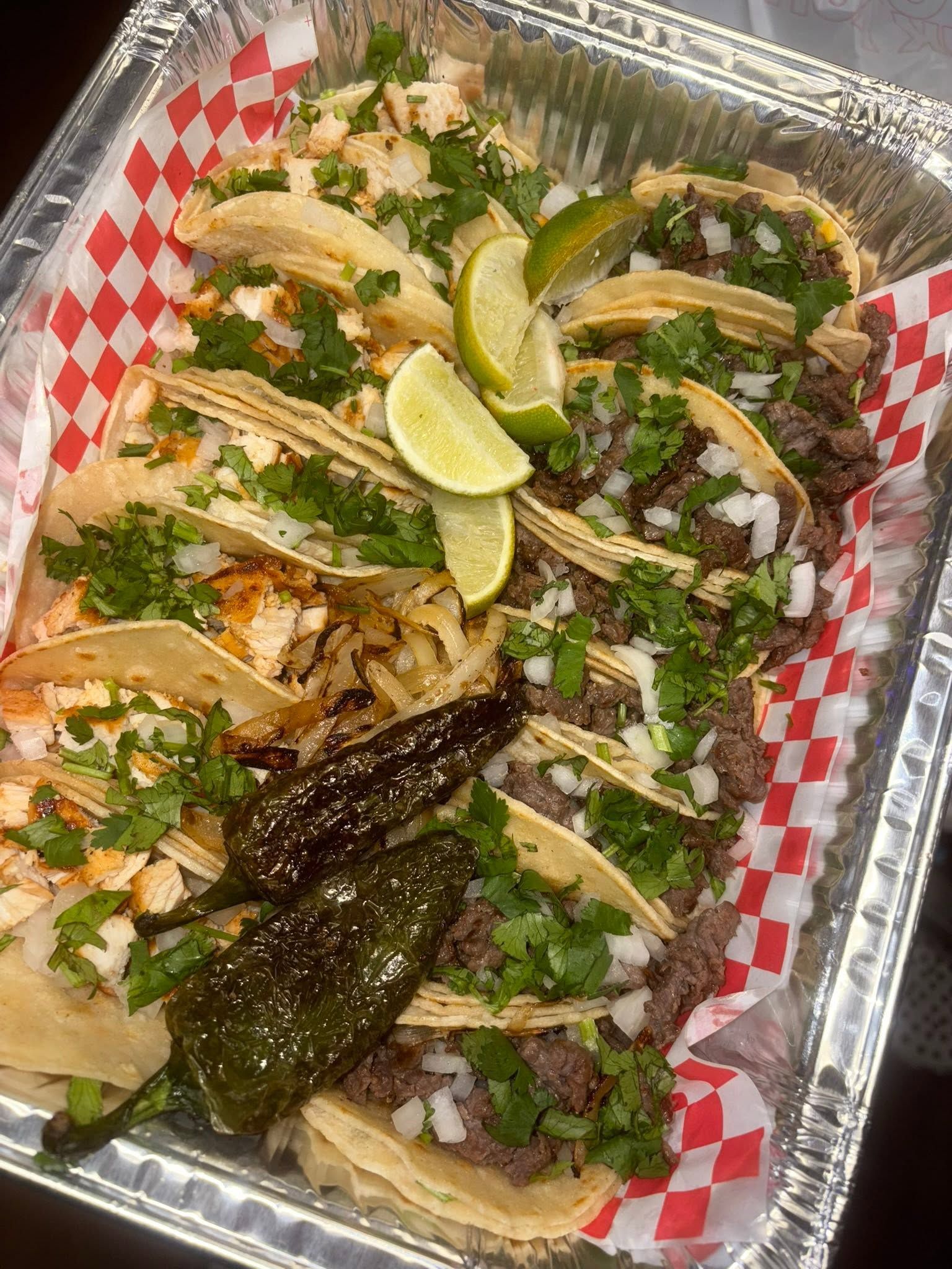 A fan of quesa tacos with grilled onion, jalapeño and lime